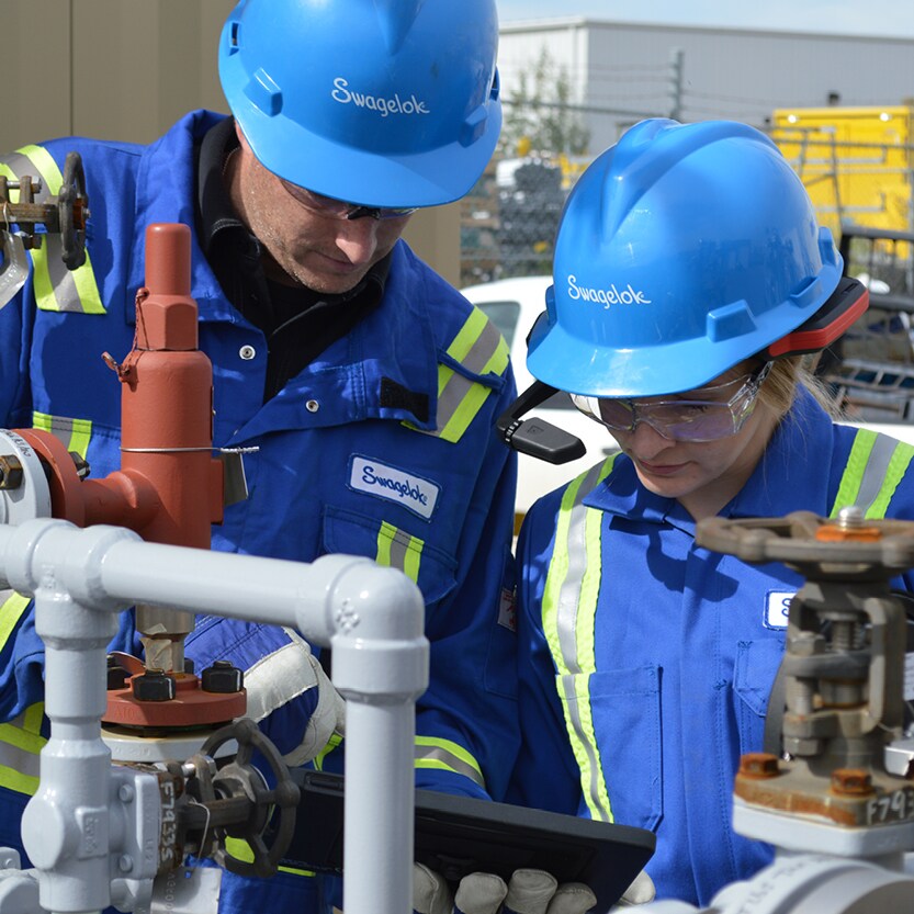 Engineers inspecting fluid system